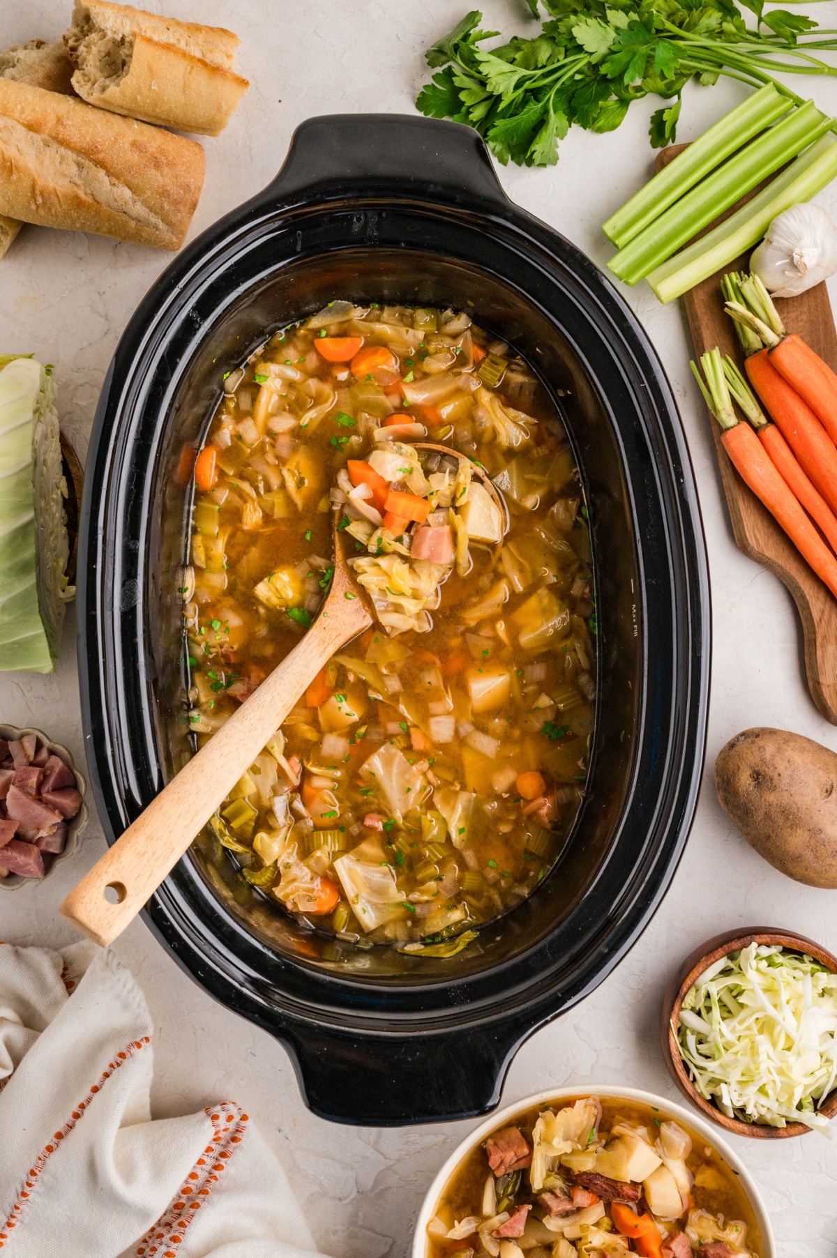 Slow cooker cabbage soup Ham cabbage soup cooking in a slow cooker with cabbage, potatoes, carrots, and ham in broth