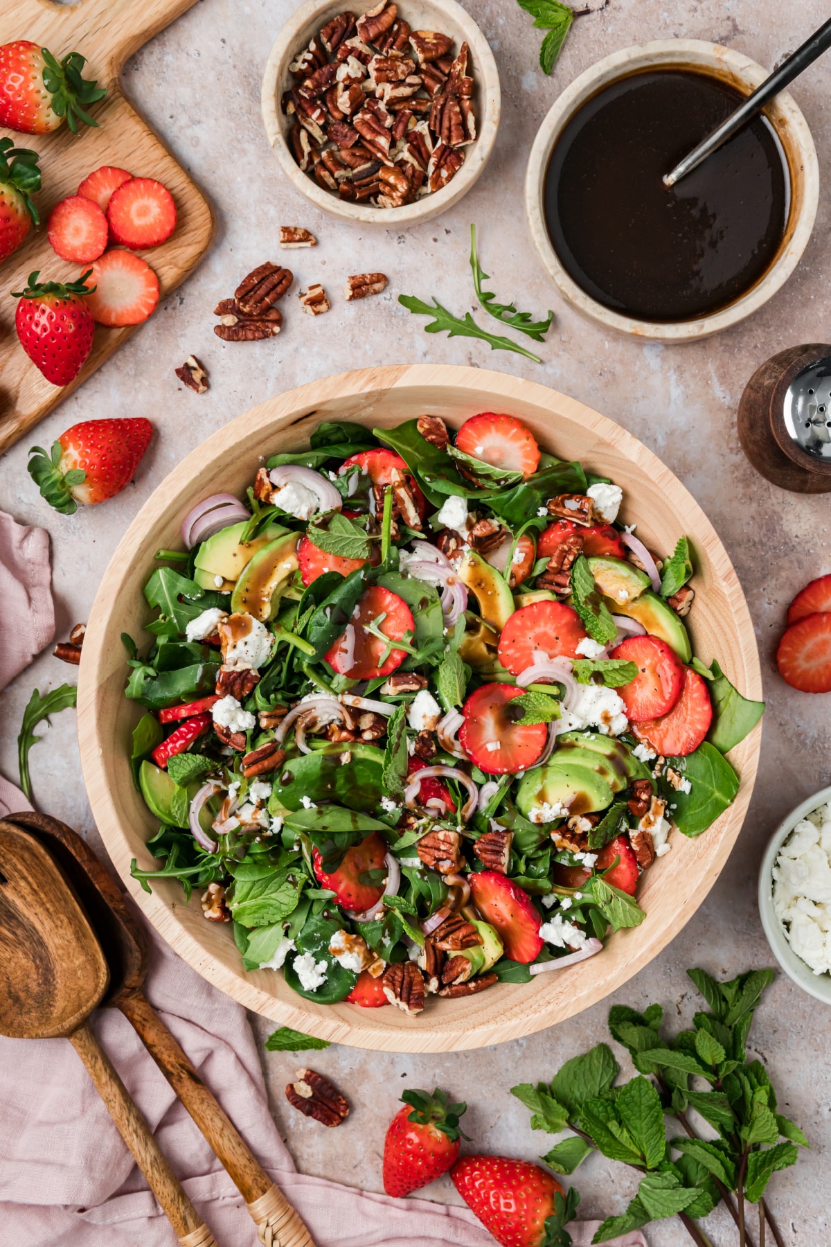 Strawberry Goat Cheese Salad with Avocado, Pecans, and Mint Strawberry goat cheese salad with avocado, pecans, mint, and balsamic vinaigrette in a wooden bowl