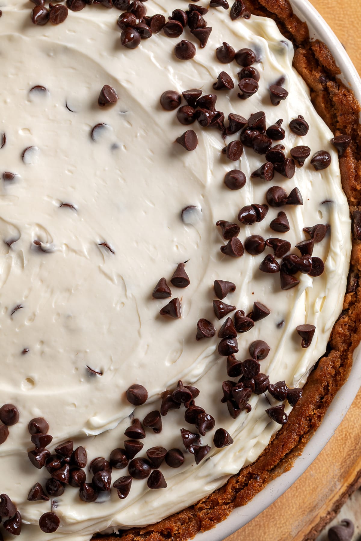Chocolate chip cookie dough crust cheesecake with creamy no-bake filling and mini chocolate chips on top