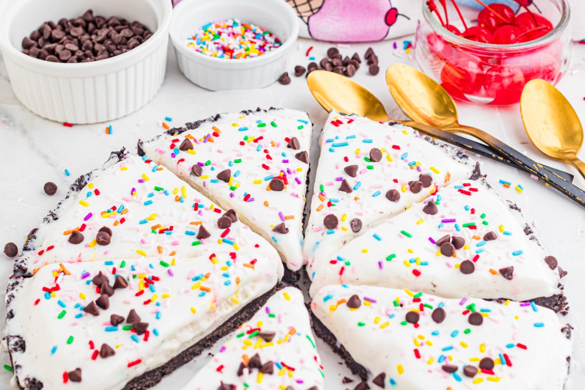 easy ice cream pizza with Oreo crust topped with sprinkles and chocolate chips