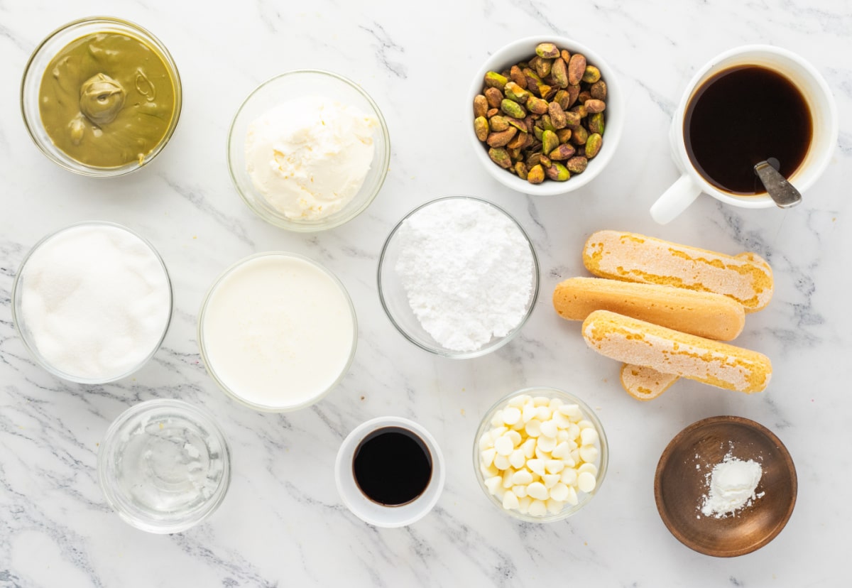 Ingredients for Pistachio Tiramisu with Mascarpone and Pistachios ingredients for pistachio tiramisu including mascarpone pistachios ladyfingers coffee white chocolate and heavy cream