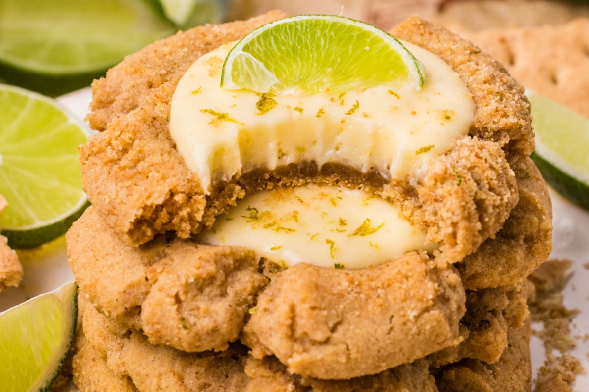 stacked graham cracker cookies filled with creamy lime curd and topped with fresh lime slice