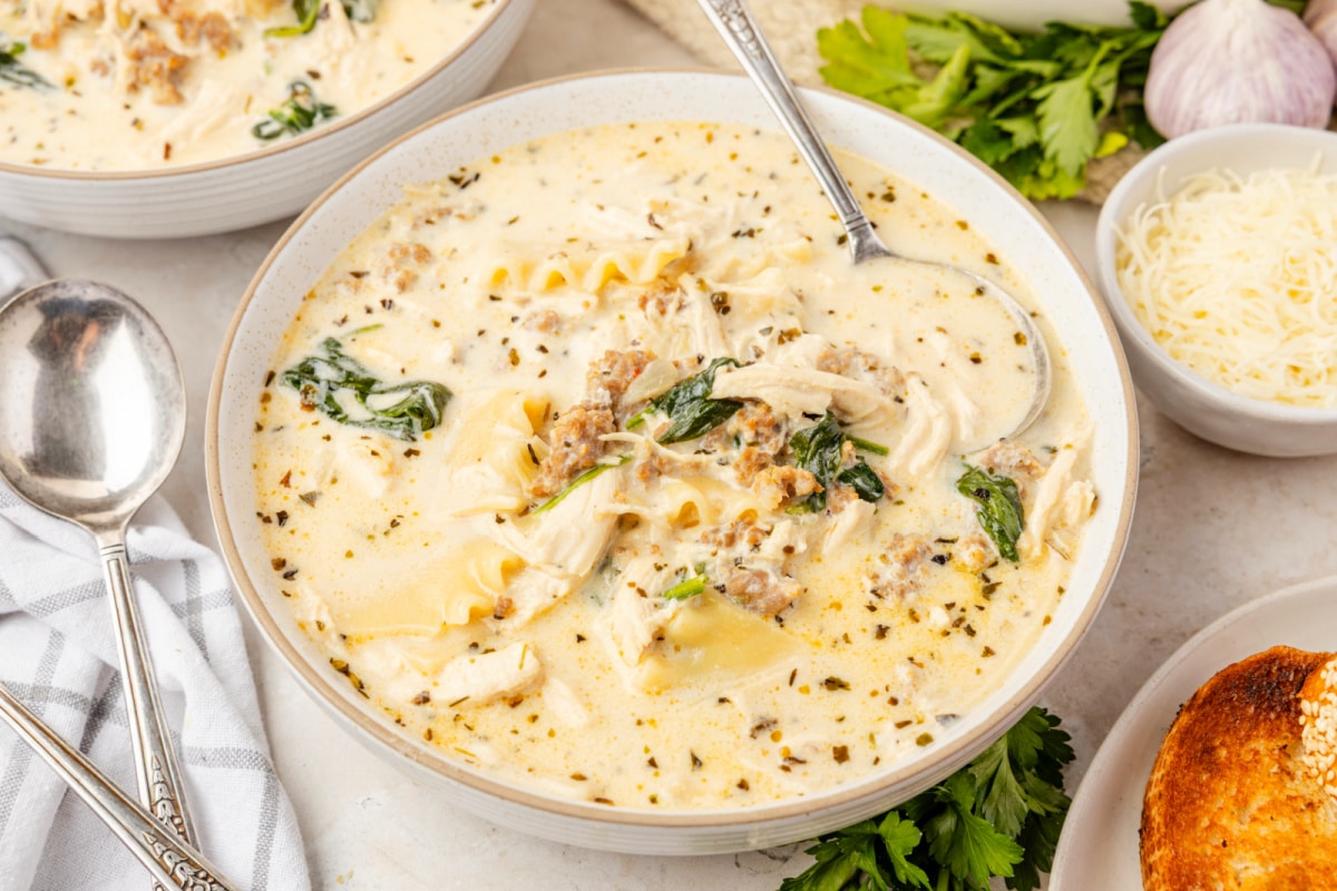 Creamy White Lasagna Soup with chicken, sausage, spinach, and broken lasagna noodles in a creamy ricotta broth