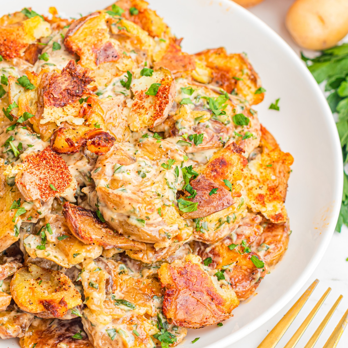 Crispy Smashed Potato Salad made with roasted smashed potatoes, lemon herb dressing, fresh parsley, dill, and crispy golden edges