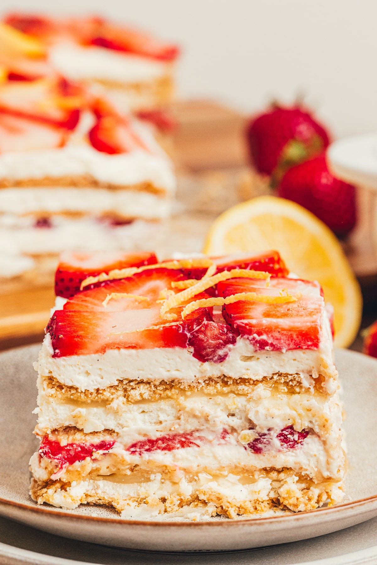 No-Bake Strawberry Lemon Icebox Cake slice with mascarpone cream and strawberries Slice of No-Bake Strawberry Lemon Icebox Cake with mascarpone whipped cream, lemon curd, graham cracker layers, and fresh strawberries.