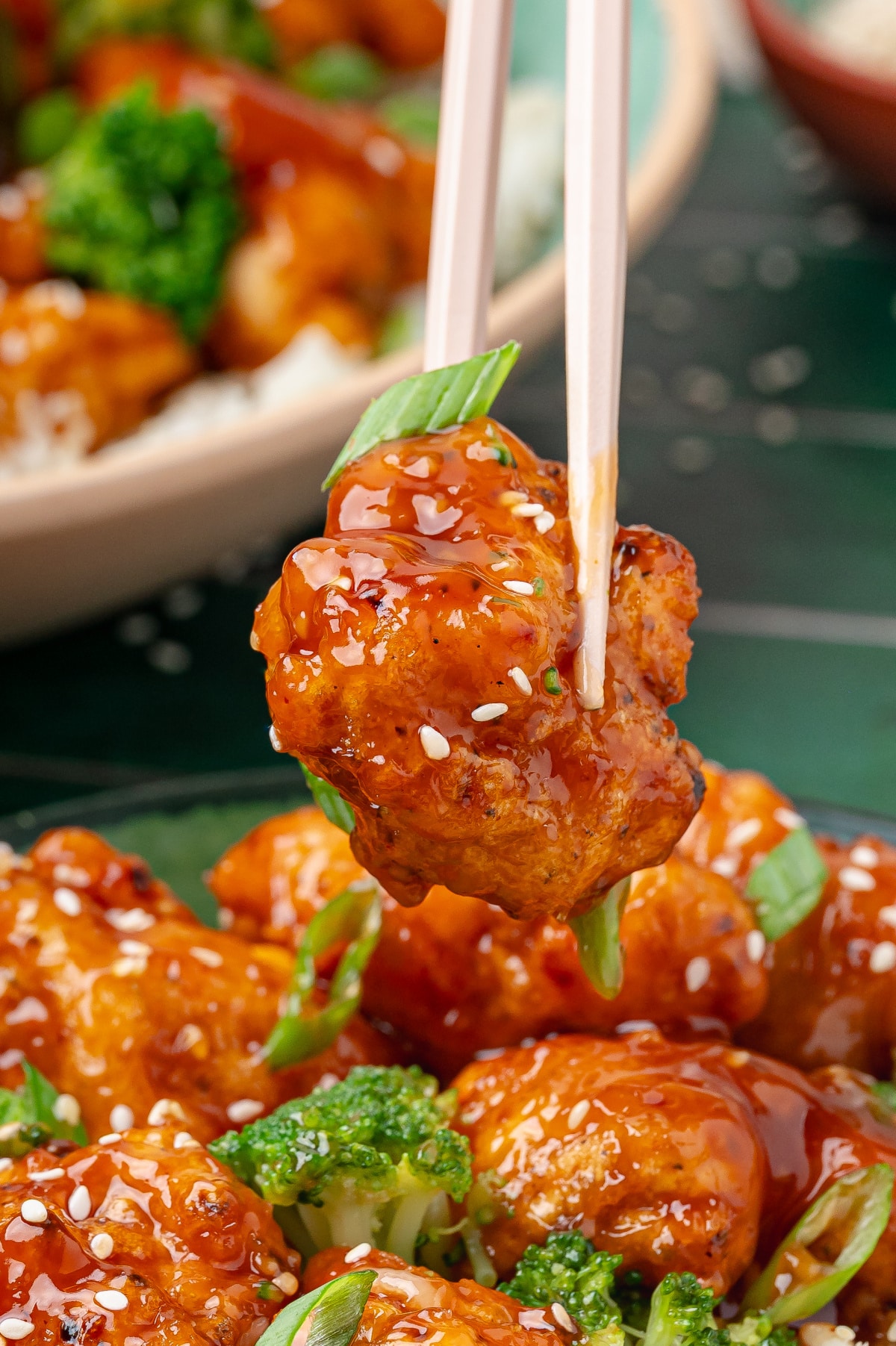 bite-of-orange-chicken-with-chopsticks