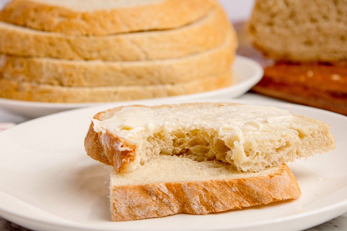Slice of peasant bread with butter showing the soft interior texture