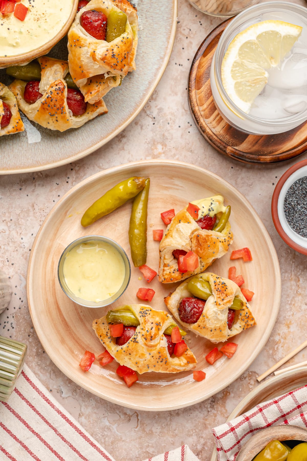 Chicago hot dog pigs in a blanket served with mustard relish dip, sport peppers, and diced tomato.