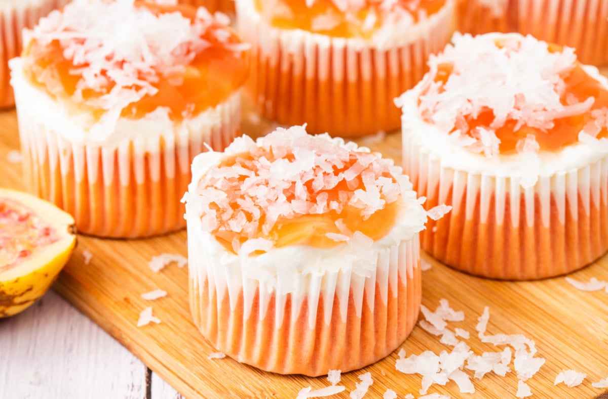 These Hawaiian guava cake cupcakes combine pink cake, a cream cheese layer, guava glaze, and coconut in every bite. Guava cream cheese cupcakes topped with guava glaze and shredded coconut