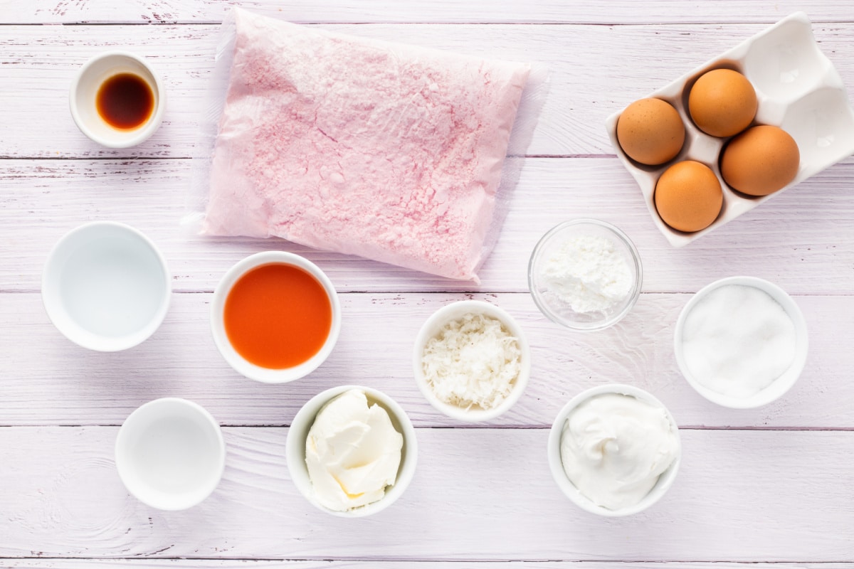 Everything needed to make guava glazed cream cheese cupcakes, including guava nectar, cream cheese, coconut, and strawberry cake mix. Ingredients for guava glazed cream cheese cupcakes including strawberry cake mix, guava nectar, cream cheese, eggs, coconut, sugar, and Cool Whip