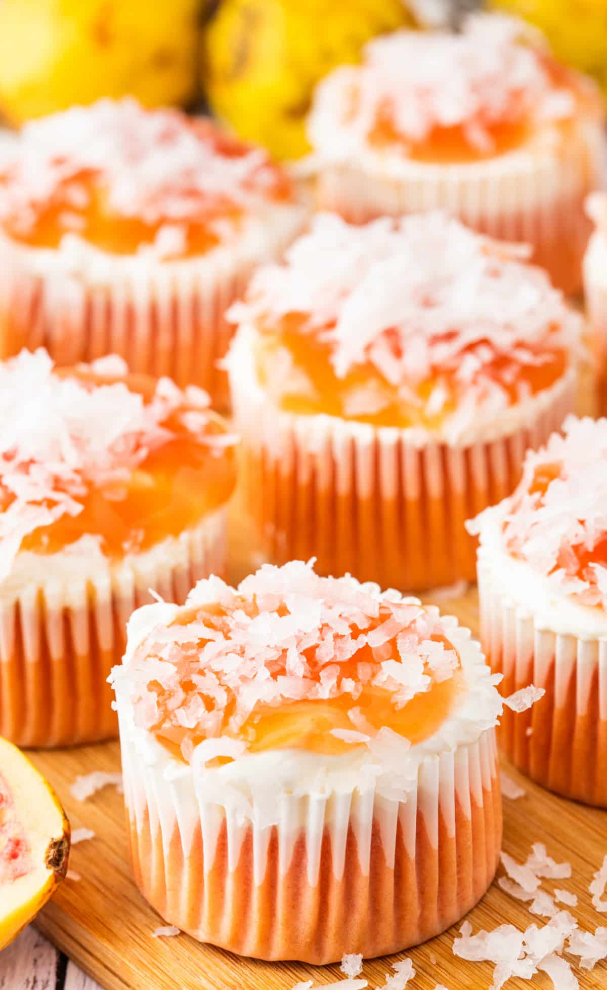 Finished guava glazed cream cheese cupcakes with creamy topping, guava glaze, and coconut. Guava glazed cream cheese cupcakes topped with guava glaze and shredded coconut