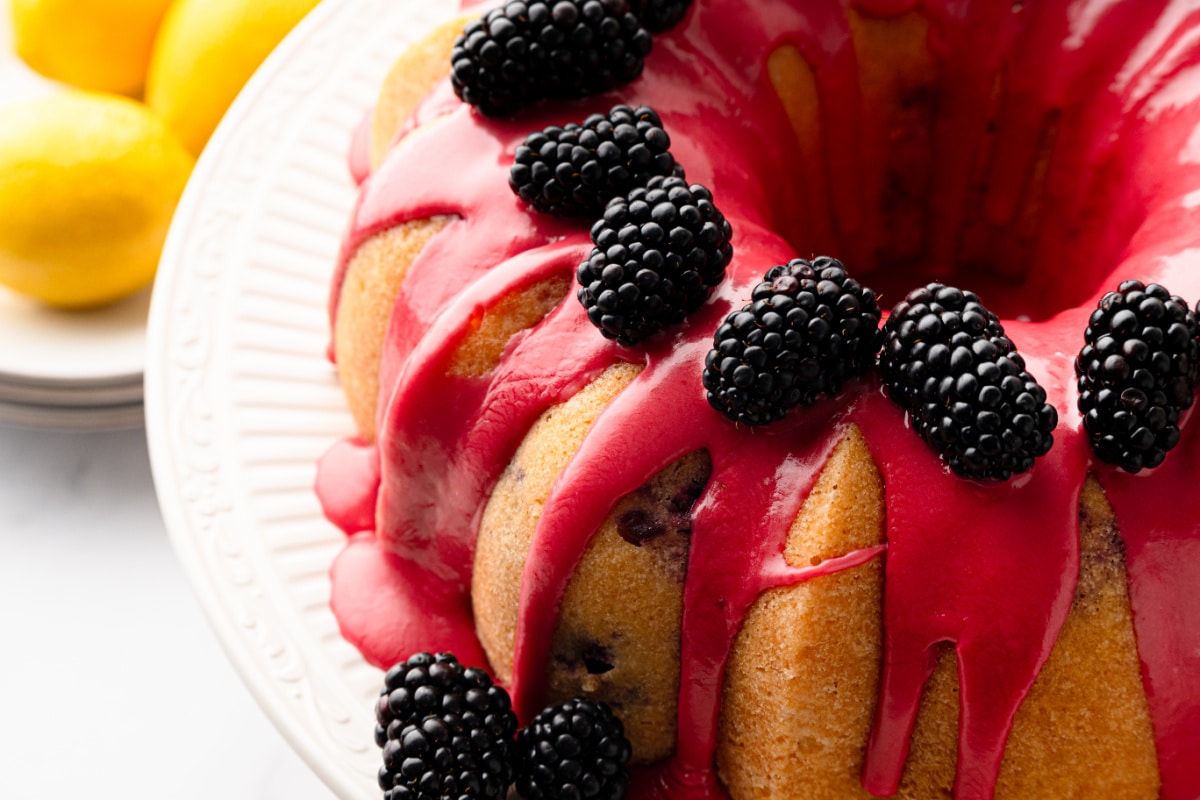 Close-up of lemon blackberry Bundt cake covered with fresh blackberry glaze and topped with whole blackberries