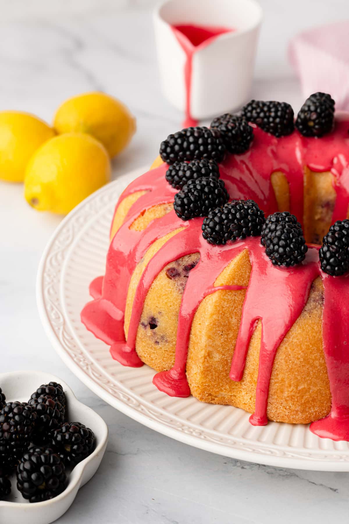 Lemon blackberry Bundt cake topped with fresh blackberry glaze and whole blackberries