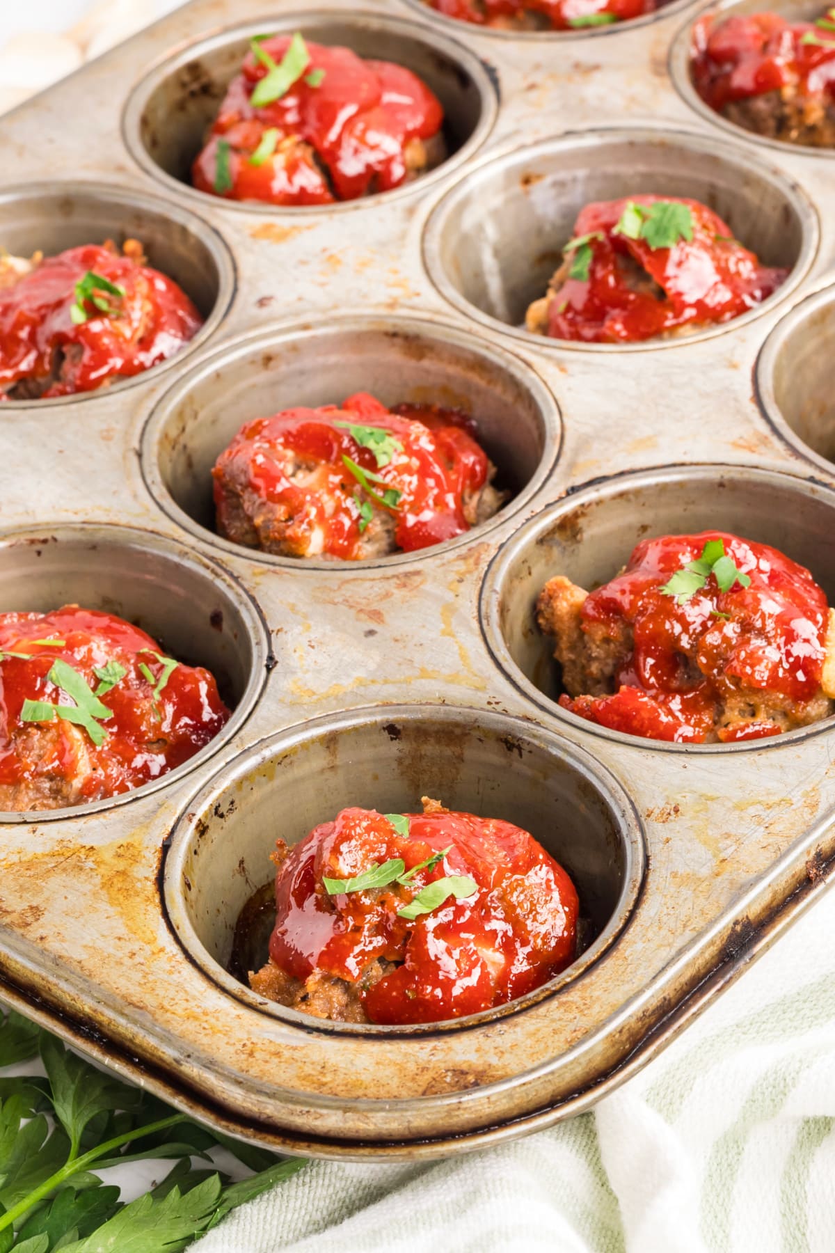 Mini meatloaf recipe fresh from the oven with caramelized edges Mini meatloaf recipe baked in a muffin tin with caramelized tomato glaze