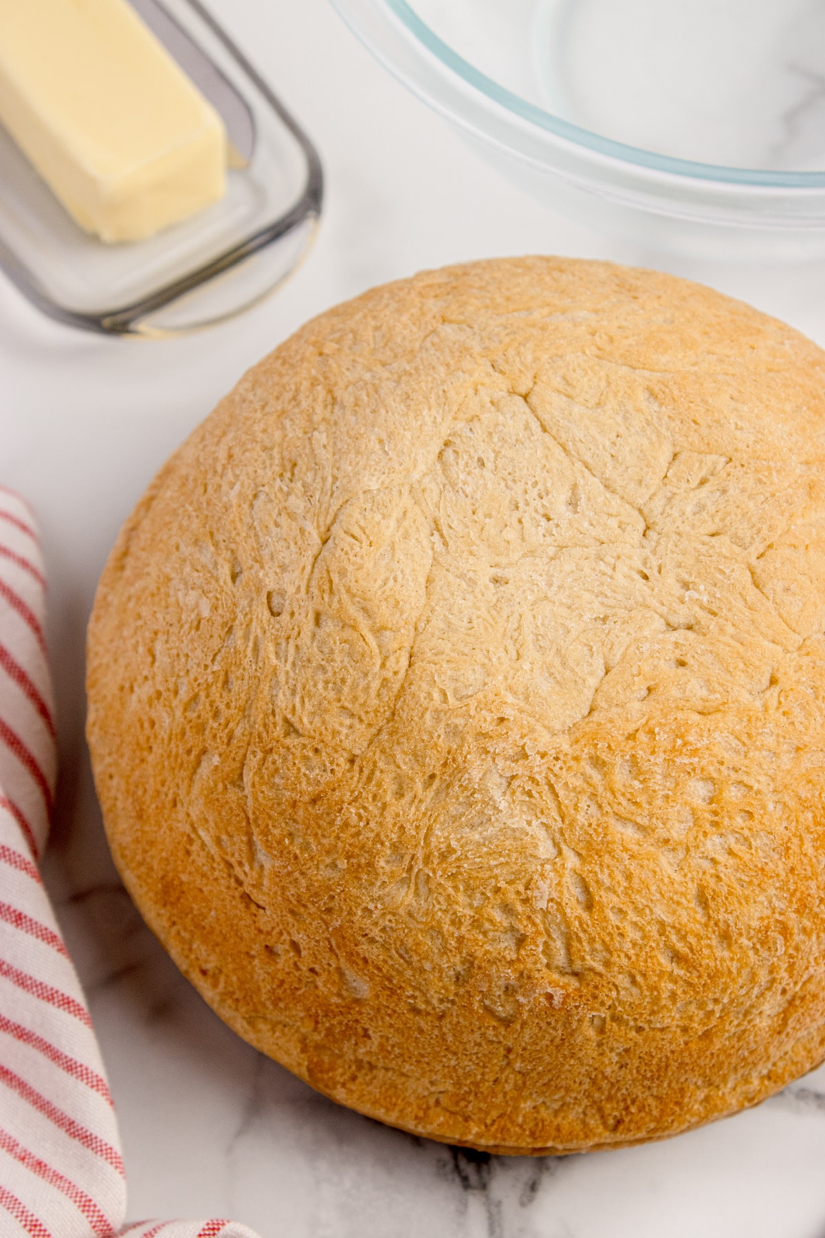 No-knead peasant bread baked in a Pyrex bowl with a golden crust