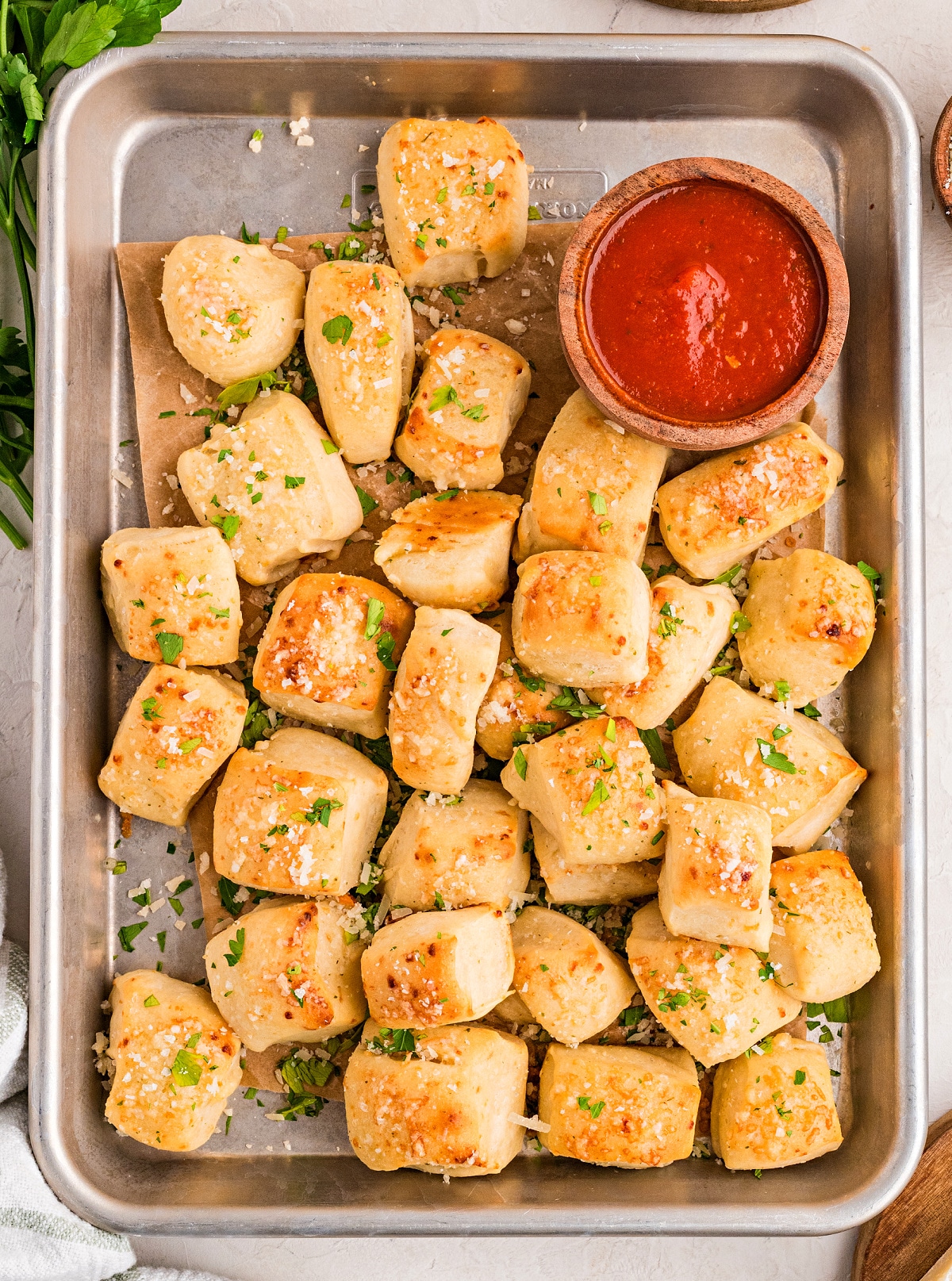 Parmesan bread bites baked until golden brown and served with marinara sauce for dipping