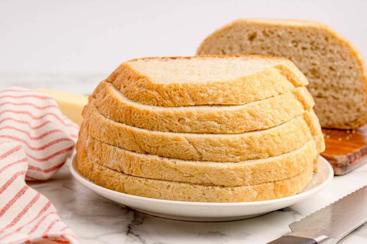 Sliced no-knead peasant bread showing the soft interior and golden crust