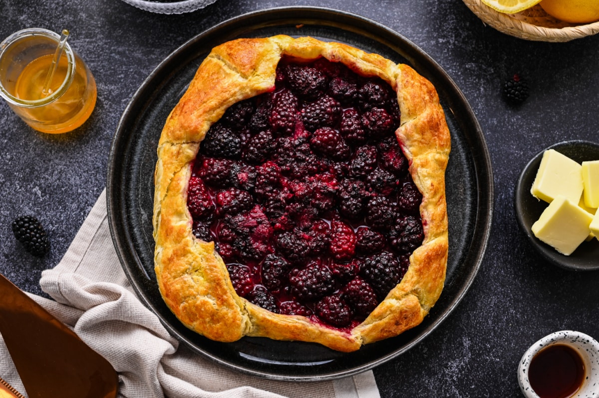 Overhead view of a blackberry puff pastry galette made with fresh blackberries and honey.