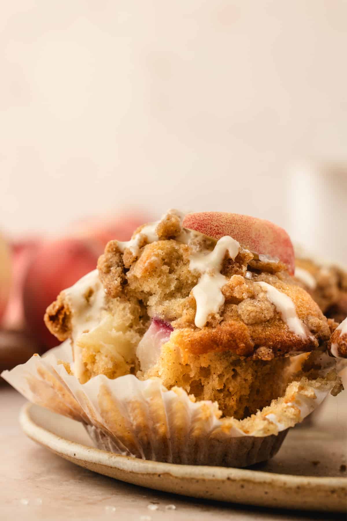 Brown butter peach coffee cake muffin with fresh peaches and cinnamon streusel Brown butter peach coffee cake muffin with fresh peaches, cinnamon streusel, and vanilla glaze