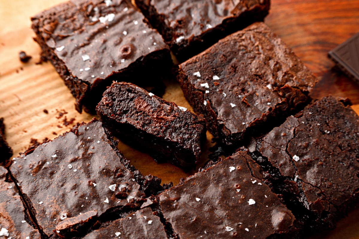 Cabernet Sauvignon brown butter brownies cut into squares in the baking pan with flaky sea salt on top.