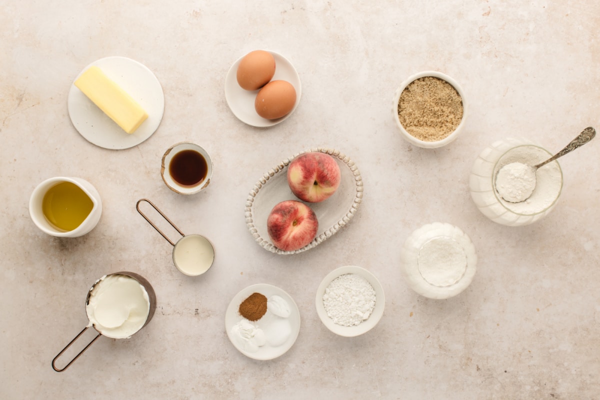 Ingredients for brown butter peach coffee cake muffins Fresh peaches, Greek yogurt, brown butter, flour, eggs, and ingredients for peach coffee cake muffins