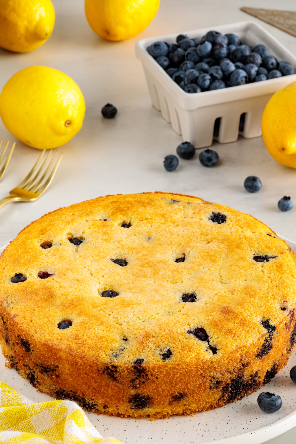 Lemon blueberry cornbread baked until golden brown with fresh blueberries in an 8-inch round pan.