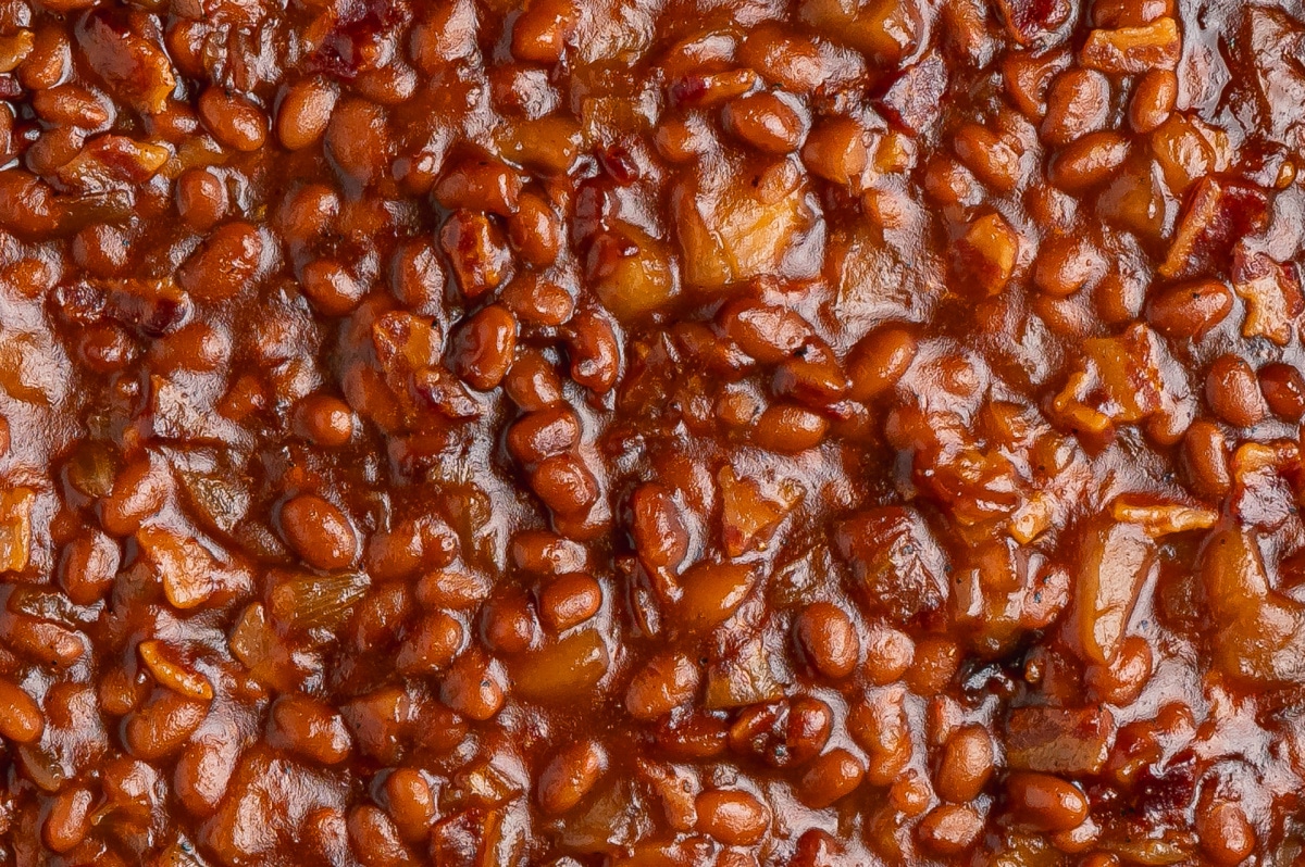 Apple Pie Baked Beans with Apple Pieces and Bacon Close-up of apple pie baked beans with pieces of apple and bacon