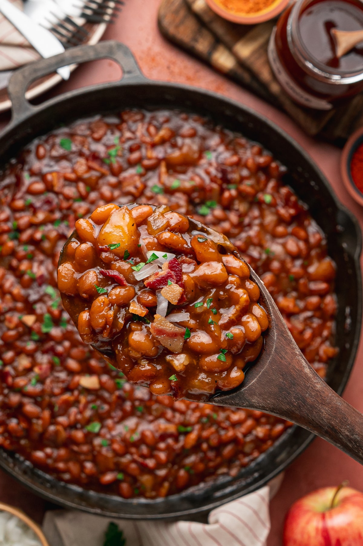 Apple Pie Baked Beans with Bacon Spoonful of apple pie baked beans with bacon and tender apple pieces