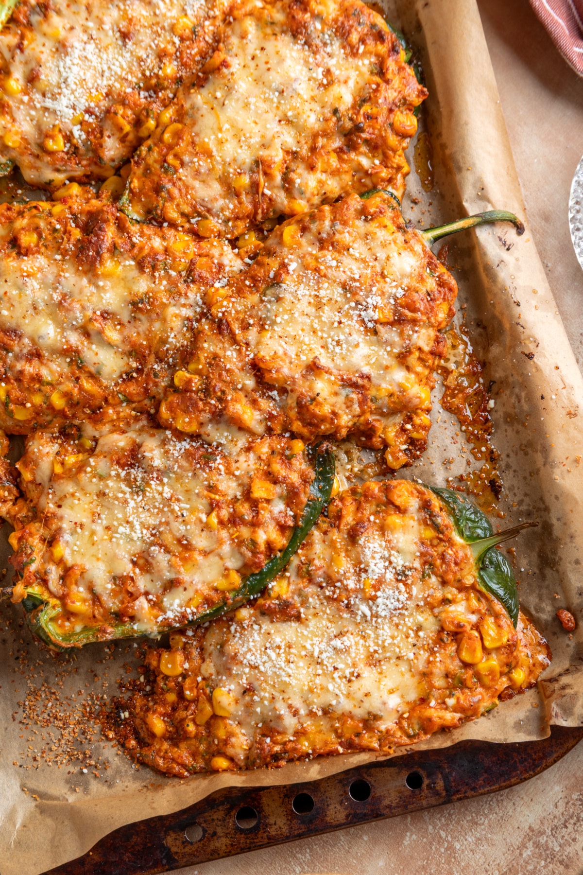 How to prepare, fill and bake poblano peppers with creamy street corn and chorizo filling Baked Mexican street corn stuffed poblano peppers filled with chorizo and corn and topped with melted cheese, Cotija and Tajín
