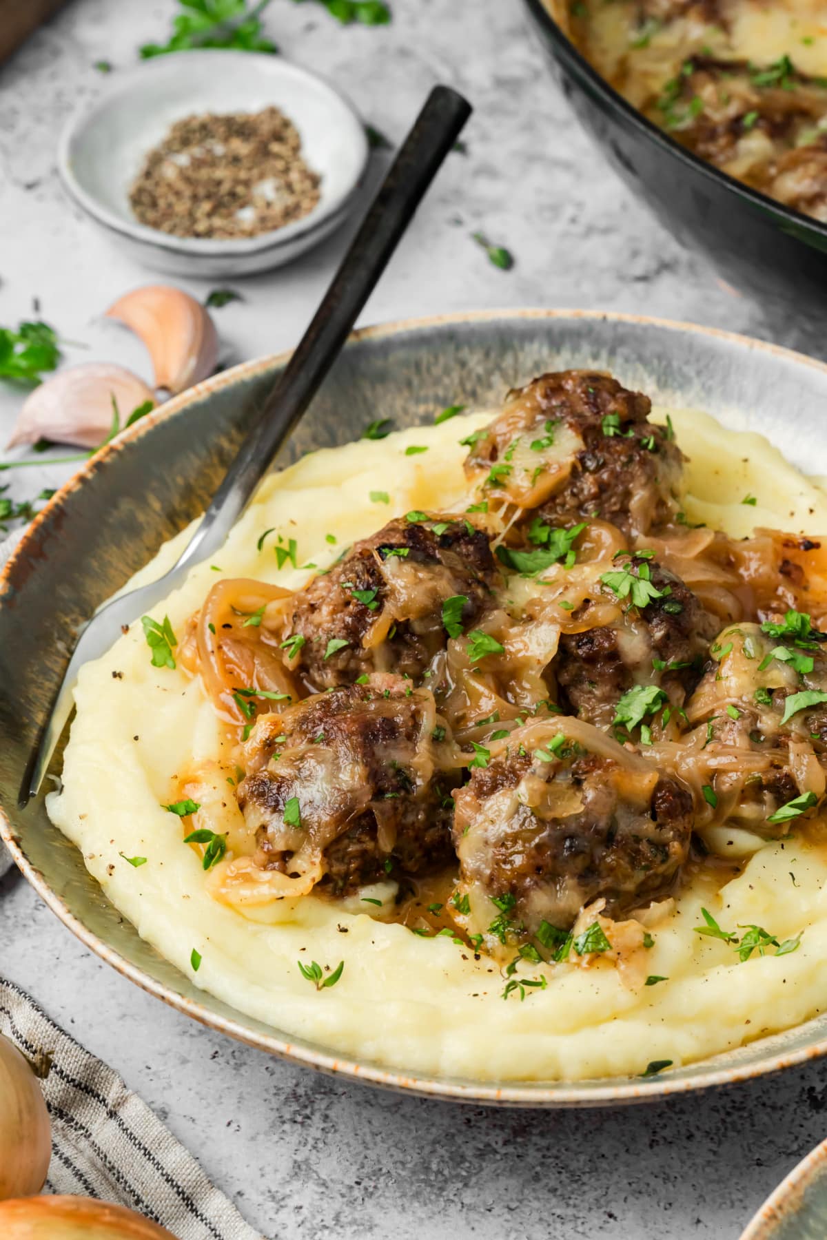 Caramelized onion meatballs with Gruyère and onion sauce over mashed potatoes