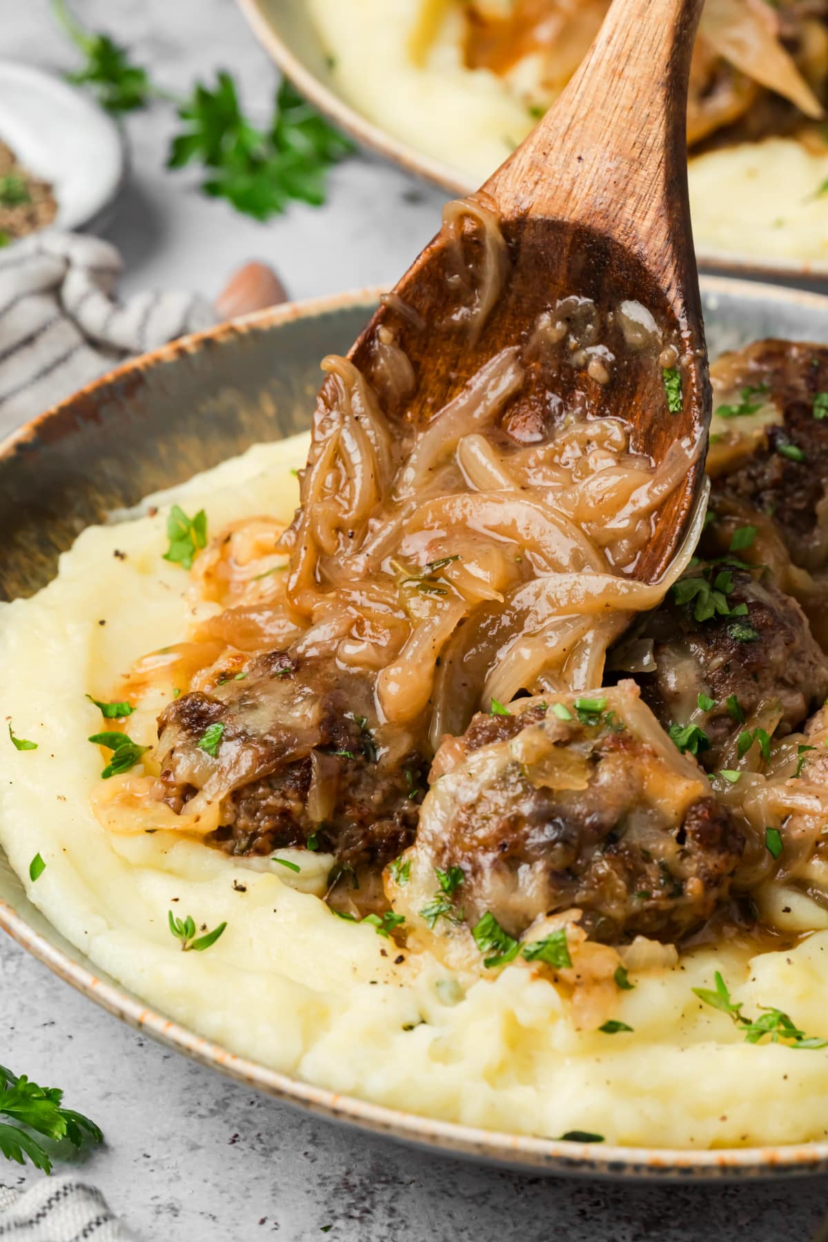 Caramelized onion sauce spooned over beef meatballs with Gruyère and mashed potatoes