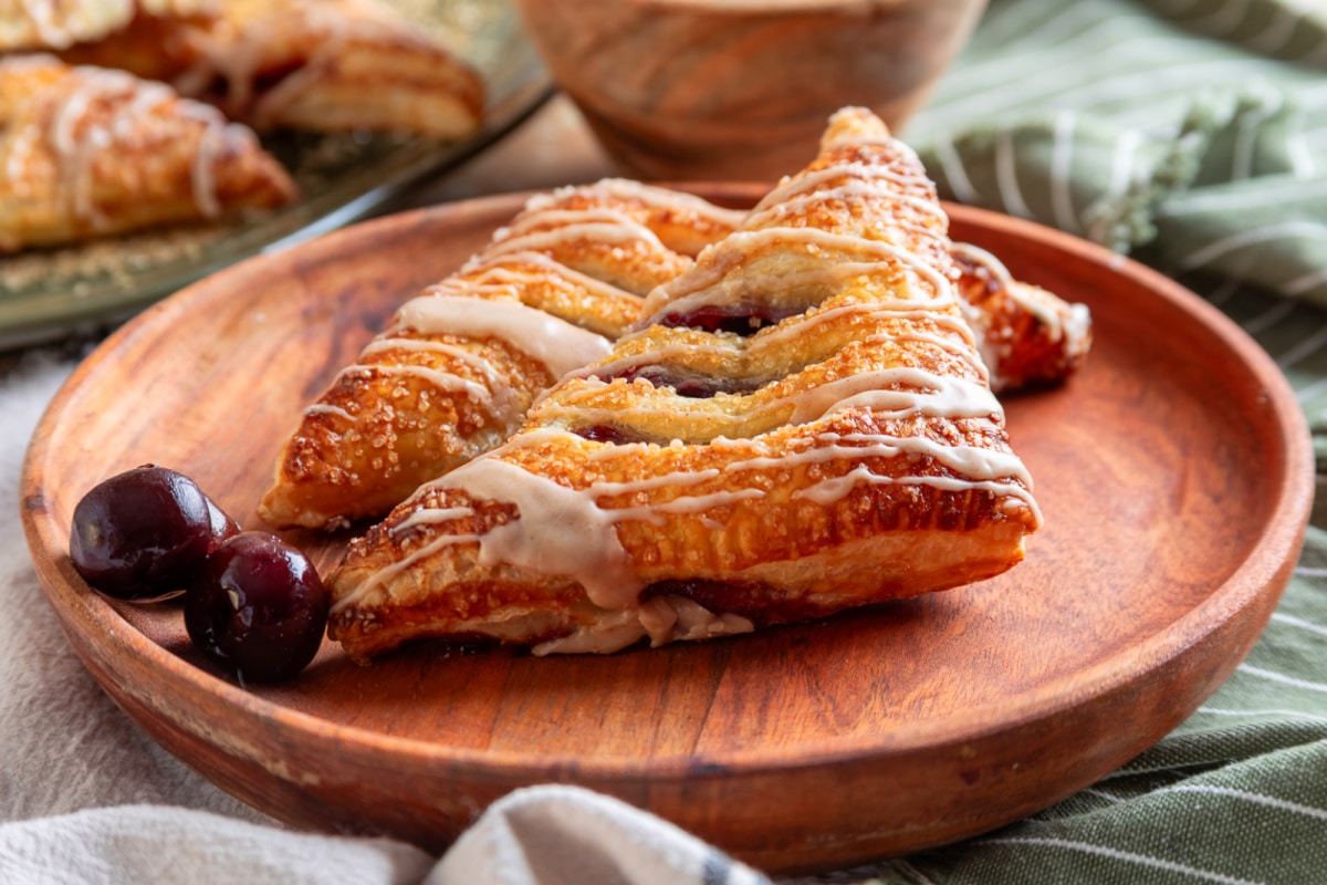 Cherry turnovers topped with cinnamon bourbon glaze and coarse sugar