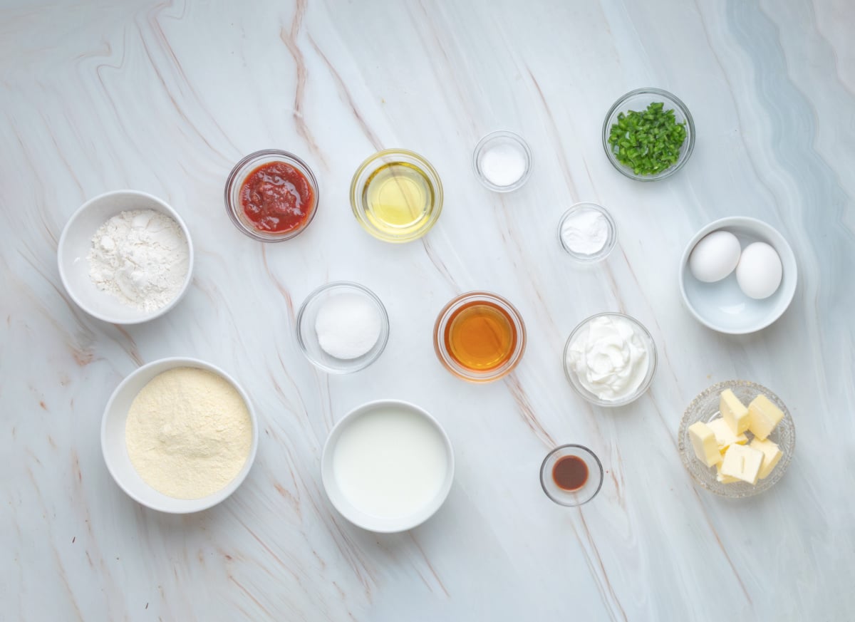 Ingredients for chipotle hot honey skillet cornbread including cornmeal, buttermilk, chipotle, jalapeño, hot honey, sour cream, eggs and butter