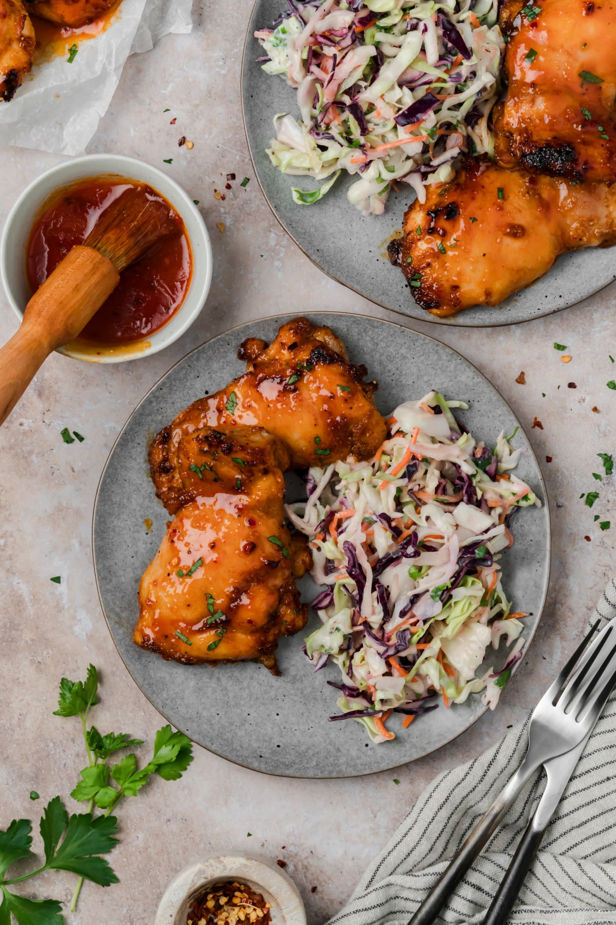 Hot honey chicken thighs served with creamy coleslaw and extra hot honey glaze on the side.