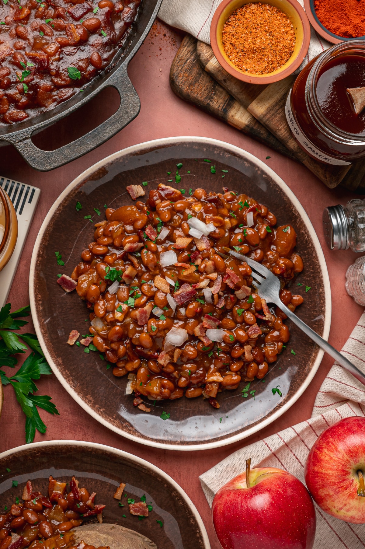 Baked Beans with Apples, Bacon and Smoky Barbecue Sauce Smoky baked beans with apple pieces, bacon and onion served on a platter
