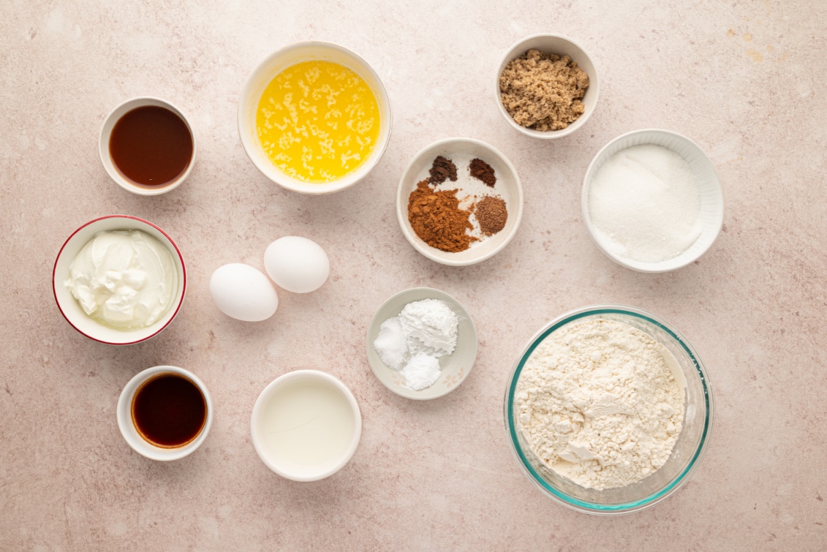 Ingredients for apple cider streusel muffins with reduced apple cider, cinnamon, nutmeg, allspice and cloves. Ingredients for apple cider streusel muffins including reduced cider, flour, sugars, buttermilk, eggs, butter and spices.
