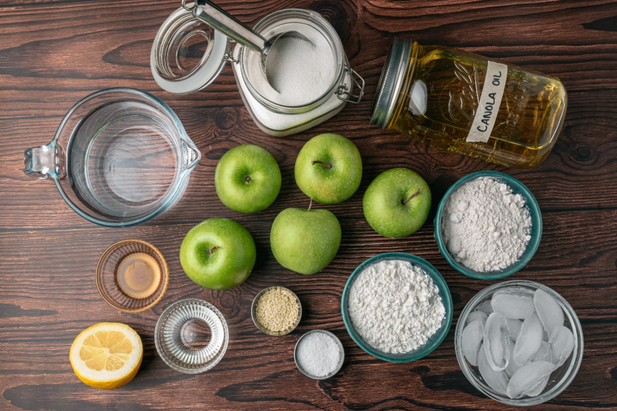 Ingredients for Chinese toffee apples including Granny Smith apples, flour, cornstarch, sugar, sesame seeds and canola oil