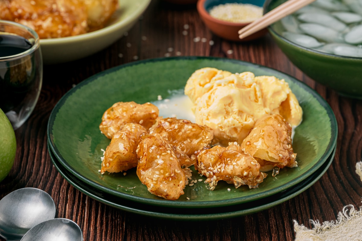 Chinese toffee apples with sesame caramel served alongside vanilla ice cream