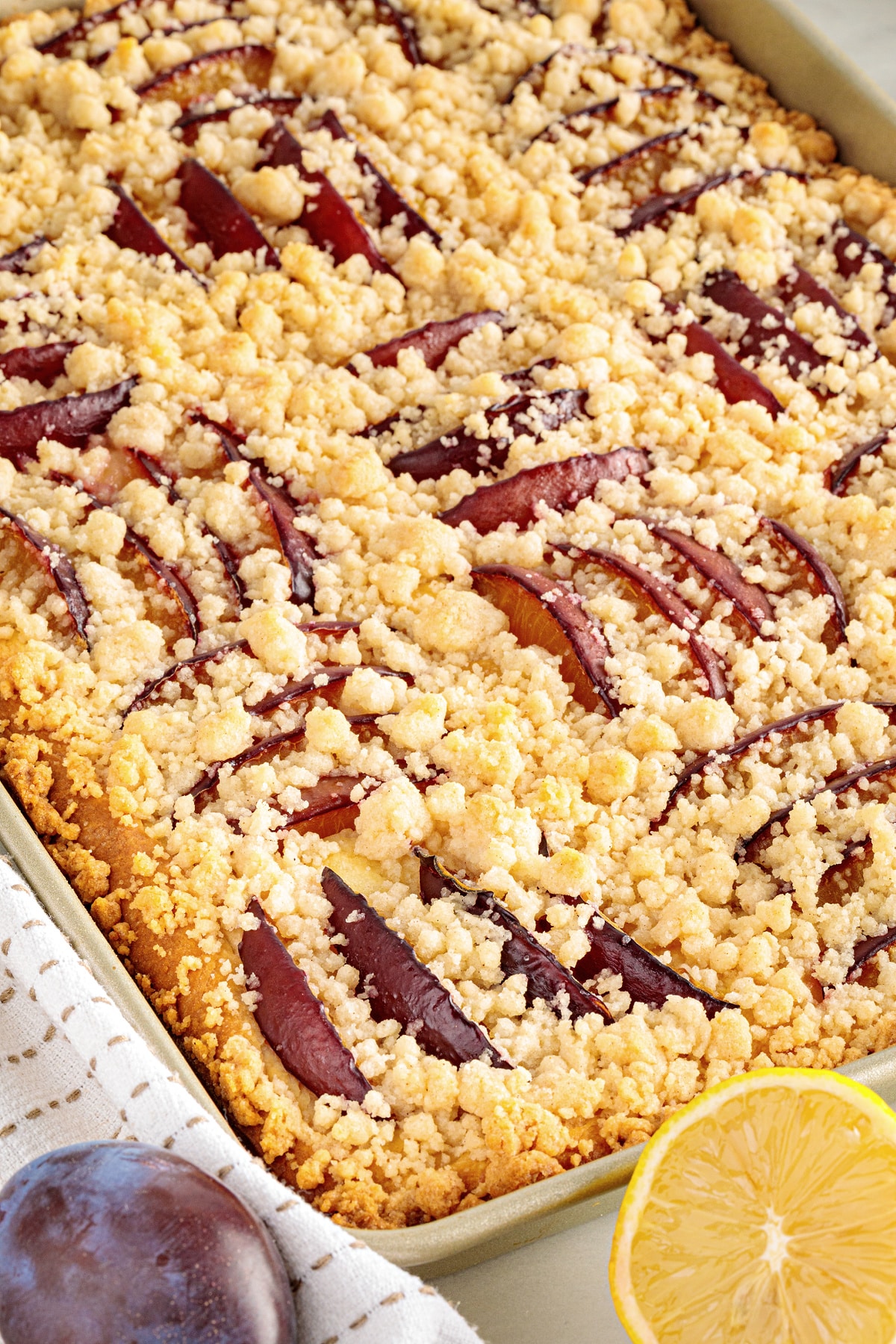 German Plum Cake with Streusel and Prune Plums German plum cake with streusel baked with sliced prune plums on a thin yeasted cake.
