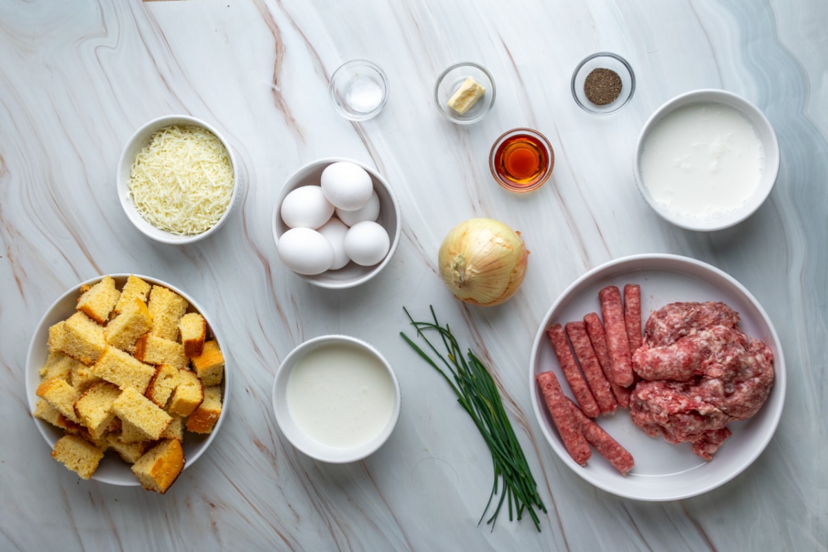 Ingredients for leftover cornbread breakfast casserole with two kinds of sausage, eggs, cheese and chives