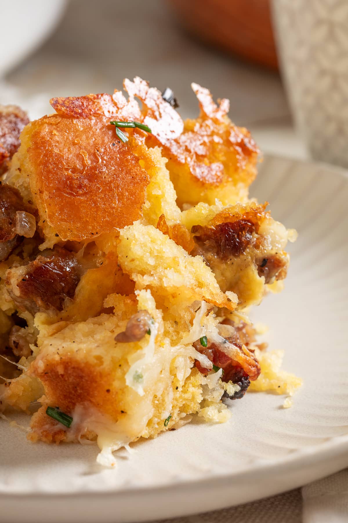 Plated leftover cornbread breakfast casserole with browned cornbread, sausage and melted cheese