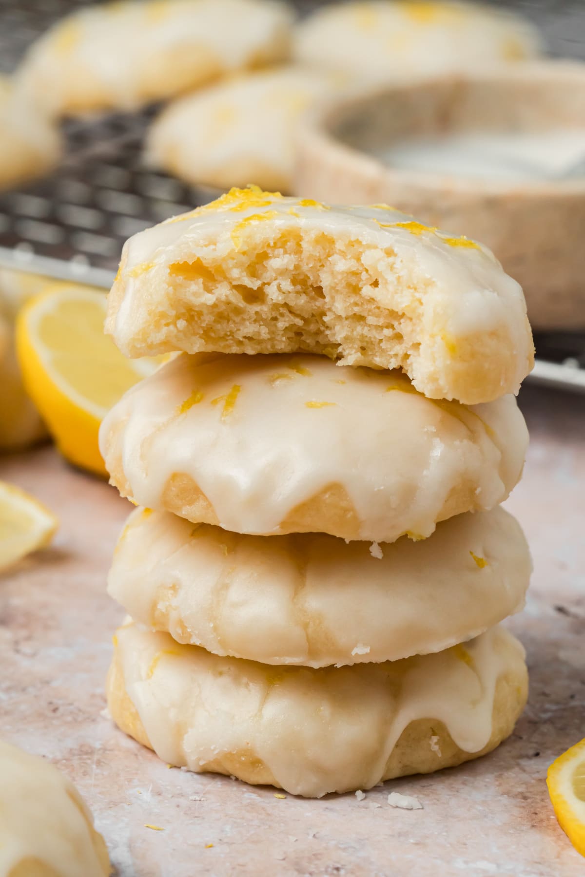 Lemon ricotta cookies with fresh lemon glaze stacked with one cookie cut open
